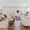 living room with kitchen island, seating and large windows
