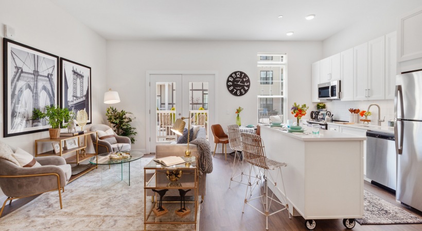 Cornerstone Living Room living room with kitchen island, seating and large windows