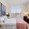 bedroom with large bed and natural light from large windows
